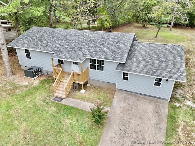 exterior space featuring driveway, a front lawn, stairway, a shingled roof, and crawl space