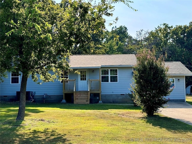 ranch-style home featuring crawl space, a porch, a shingled roof, and a front lawn