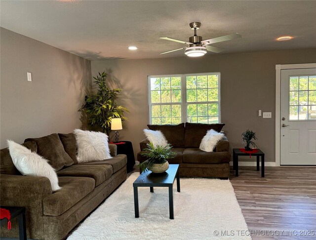 living area with recessed lighting, ceiling fan, baseboards, and wood finished floors