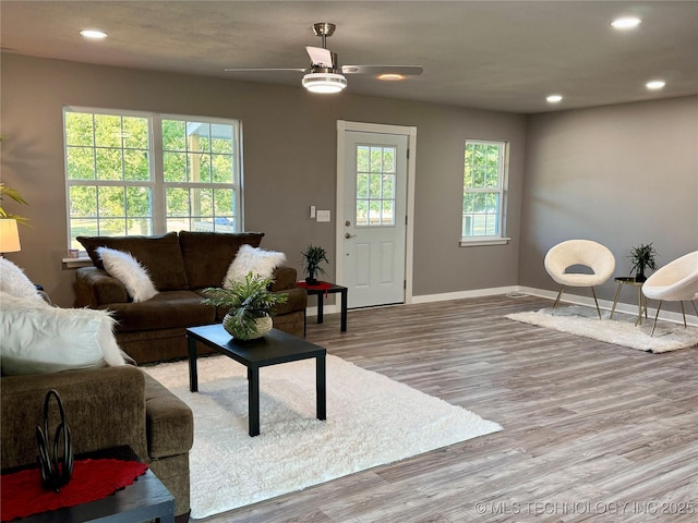 living room with recessed lighting, ceiling fan, baseboards, and wood finished floors