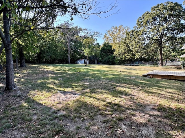 view of yard featuring an outbuilding and a storage shed