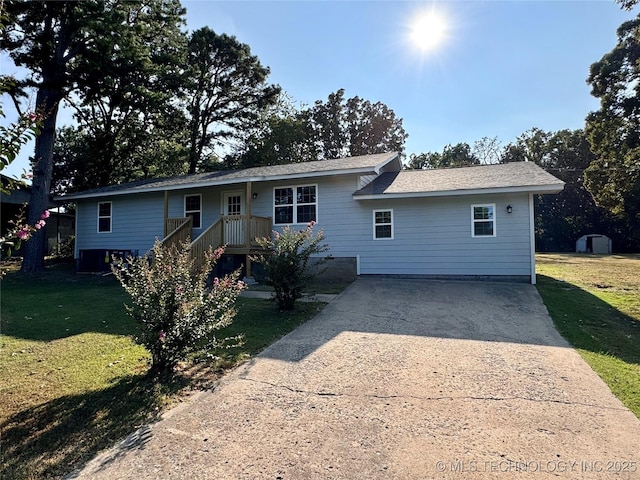 single story home with a front yard and driveway