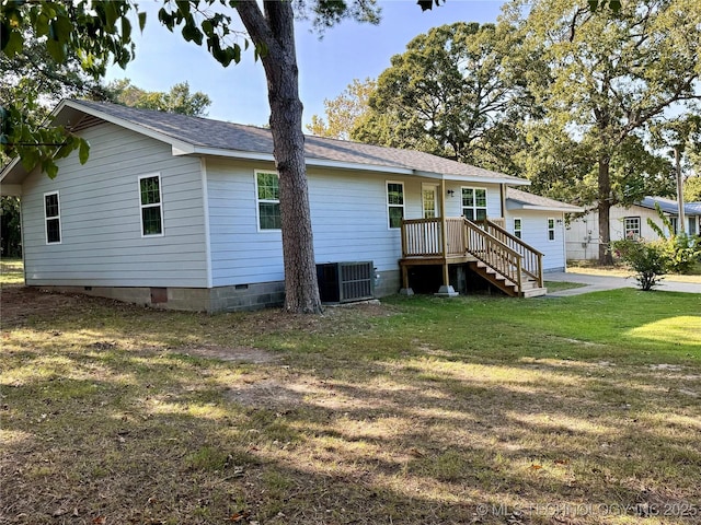 back of house featuring central air condition unit, a lawn, and crawl space