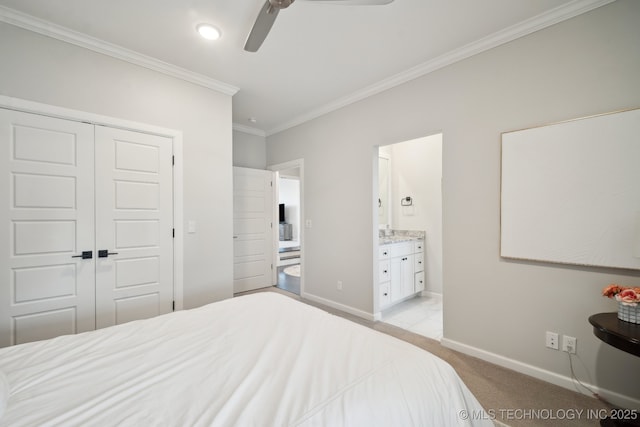 bedroom featuring baseboards, ornamental molding, a closet, ensuite bathroom, and light colored carpet