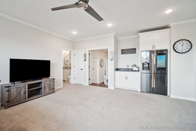 living room featuring recessed lighting, light colored carpet, crown molding, and baseboards