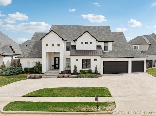 modern farmhouse featuring a standing seam roof, concrete driveway, metal roof, and a shingled roof