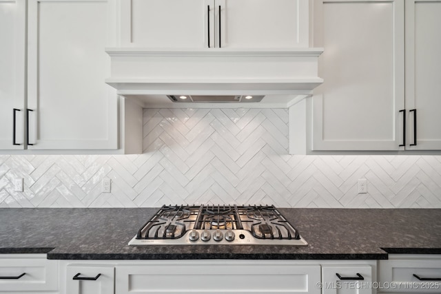 kitchen with white cabinetry, backsplash, and stainless steel gas cooktop