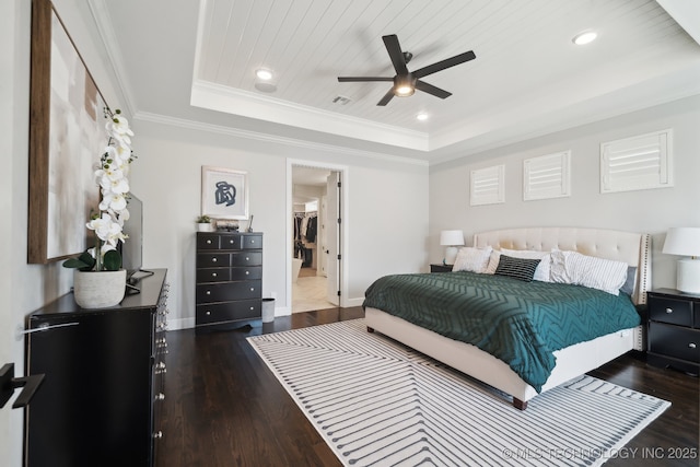 bedroom featuring wood finished floors, a tray ceiling, recessed lighting, crown molding, and wooden ceiling