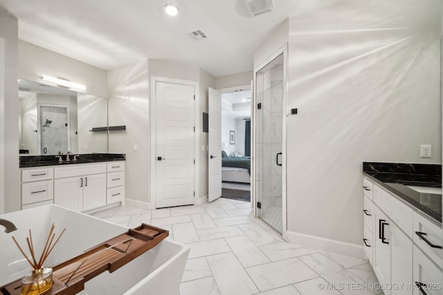 ensuite bathroom with visible vents, marble finish floor, a sink, a shower stall, and baseboards