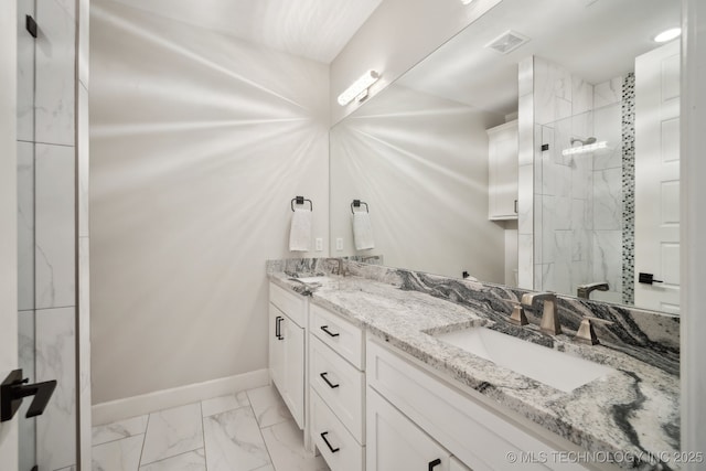 bathroom featuring visible vents, baseboards, tiled shower, marble finish floor, and a sink