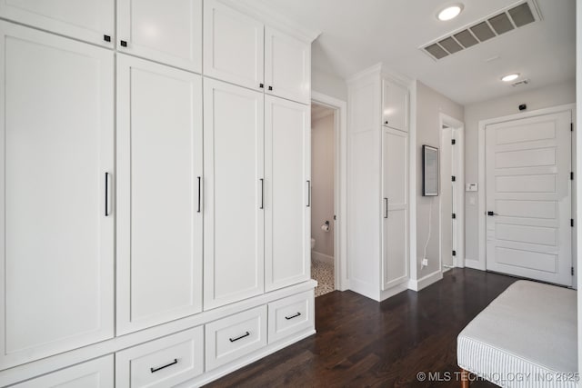 interior space featuring dark wood finished floors, visible vents, recessed lighting, and baseboards