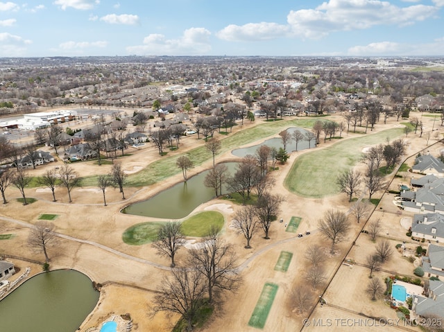 drone / aerial view featuring a water view and view of golf course