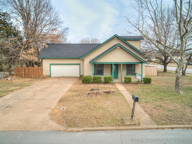 view of front of house with driveway, fence, roof with shingles, covered porch, and an attached garage