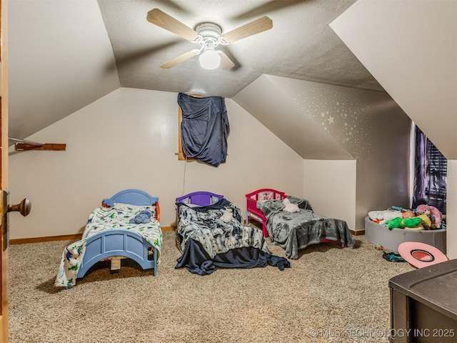 carpeted bedroom featuring baseboards, lofted ceiling, a textured ceiling, and a ceiling fan