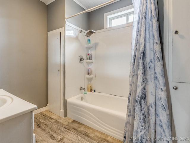 full bathroom featuring wood finished floors and shower / bath combo with shower curtain