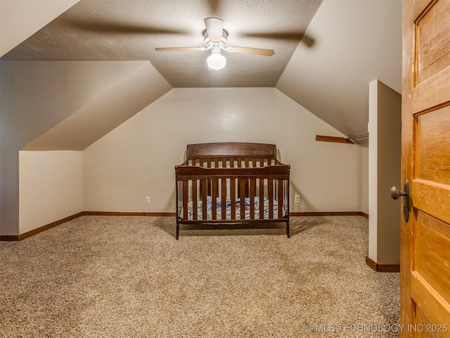 carpeted bedroom with baseboards, lofted ceiling, and a textured ceiling