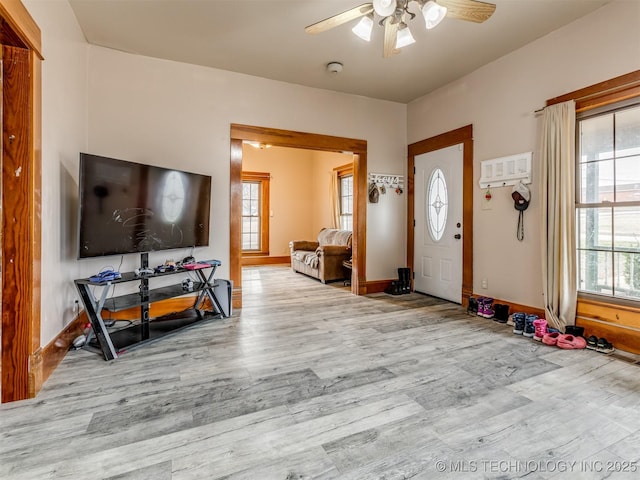 entryway with baseboards, wood finished floors, and a ceiling fan