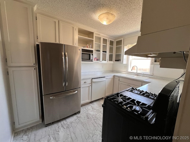 kitchen featuring marble finish floor, a sink, open shelves, appliances with stainless steel finishes, and light countertops