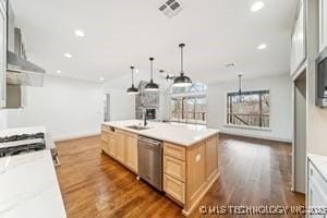 kitchen featuring visible vents, dishwasher, dark wood finished floors, and light brown cabinetry