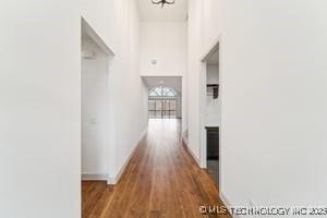 hall featuring baseboards and wood finished floors