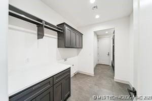 laundry room with recessed lighting and baseboards