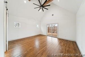 unfurnished room with beamed ceiling, high vaulted ceiling, and wood finished floors