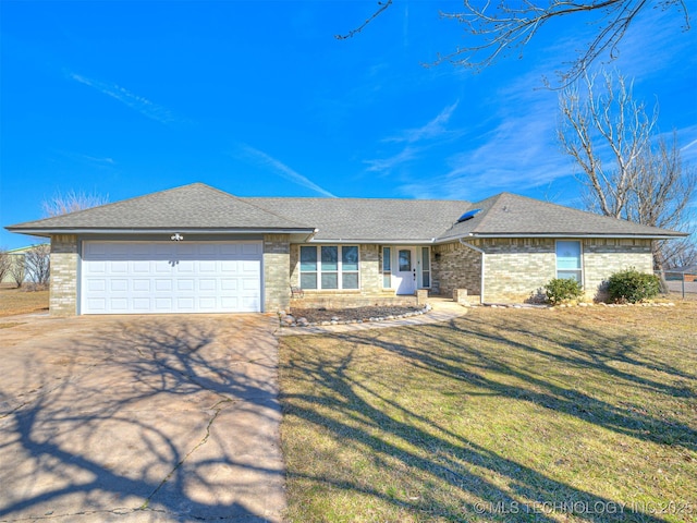 single story home featuring a garage, driveway, a front lawn, and roof with shingles