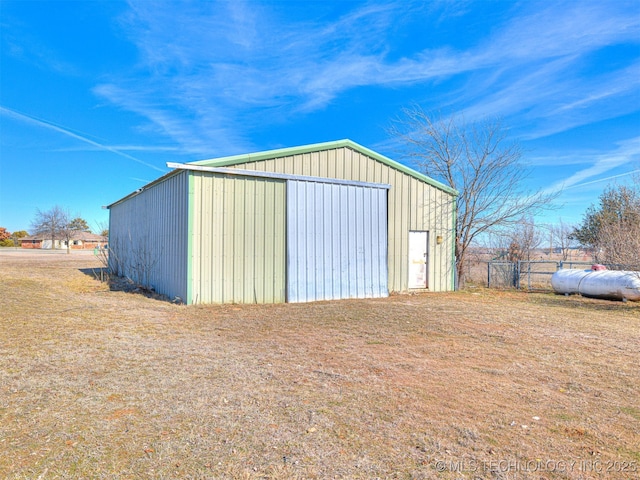 view of pole building with fence