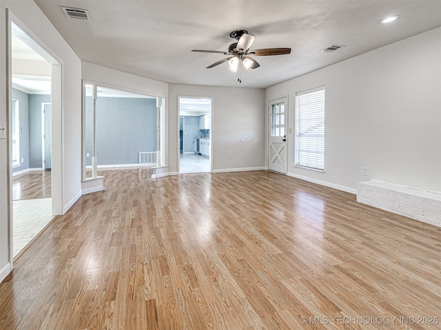 spare room with visible vents, baseboards, and light wood-style flooring