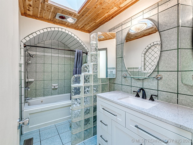 full bath with visible vents, a skylight, tile patterned flooring, wood ceiling, and tile walls