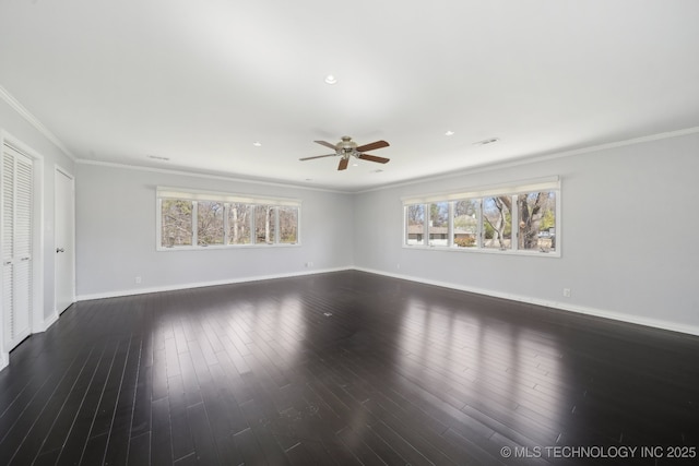 empty room featuring a healthy amount of sunlight, crown molding, ceiling fan, and wood finished floors