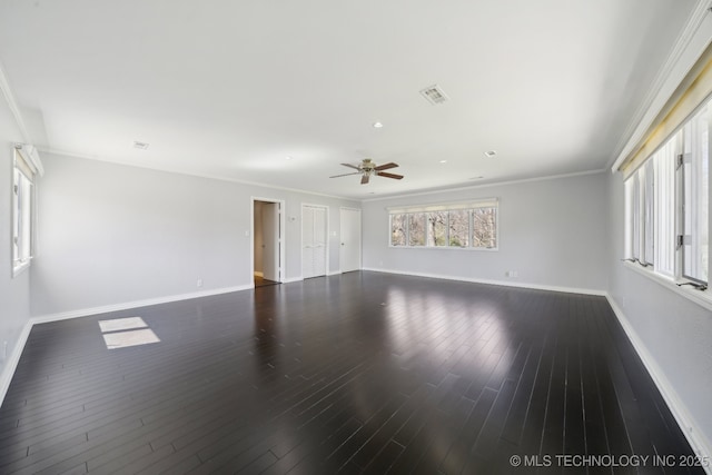 unfurnished room featuring visible vents, ornamental molding, a ceiling fan, baseboards, and dark wood-style flooring