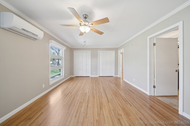 empty room with ceiling fan, light wood-style flooring, ornamental molding, and a wall mounted AC