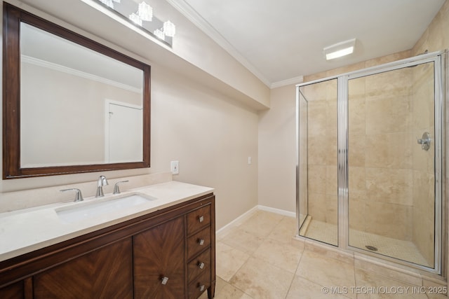 full bathroom with vanity, baseboards, ornamental molding, a shower stall, and tile patterned floors