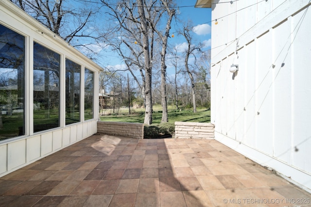 view of patio featuring a sunroom