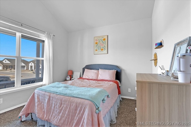 carpeted bedroom featuring baseboards and vaulted ceiling