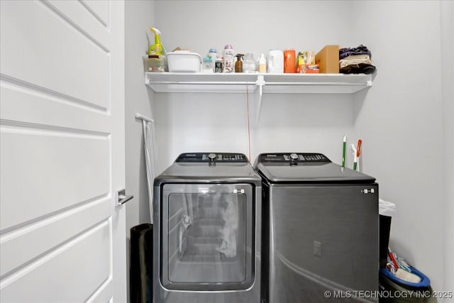 clothes washing area with independent washer and dryer and laundry area