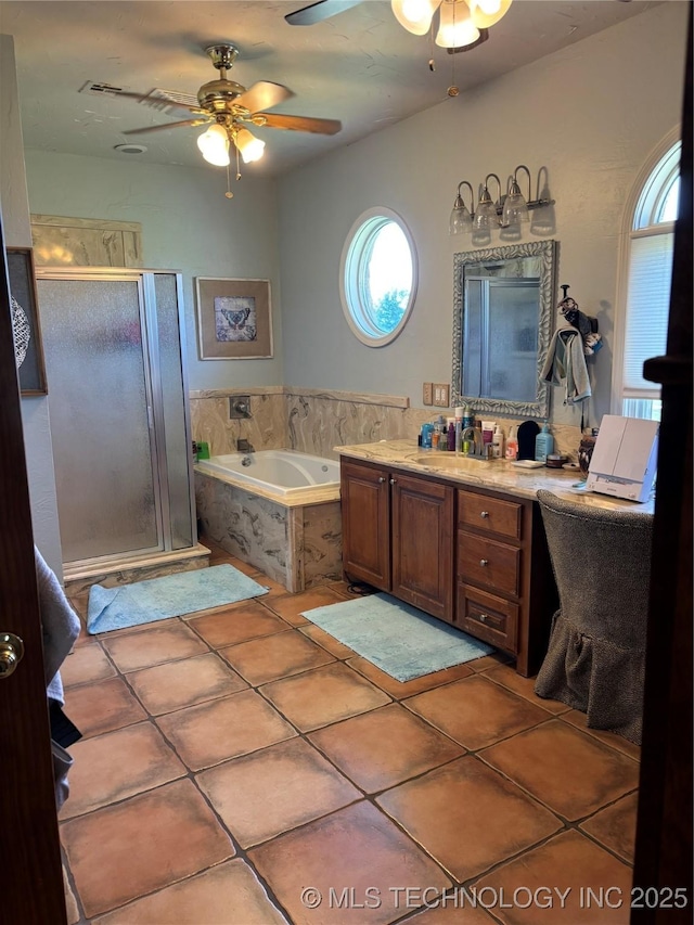 full bathroom featuring vanity, ceiling fan, a shower stall, and tile patterned floors