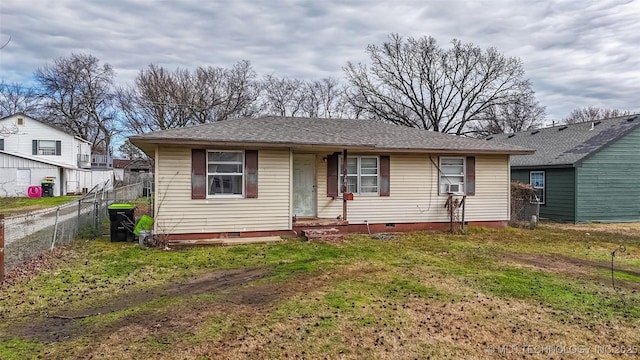 view of front facade with crawl space, a shingled roof, a front yard, and fence