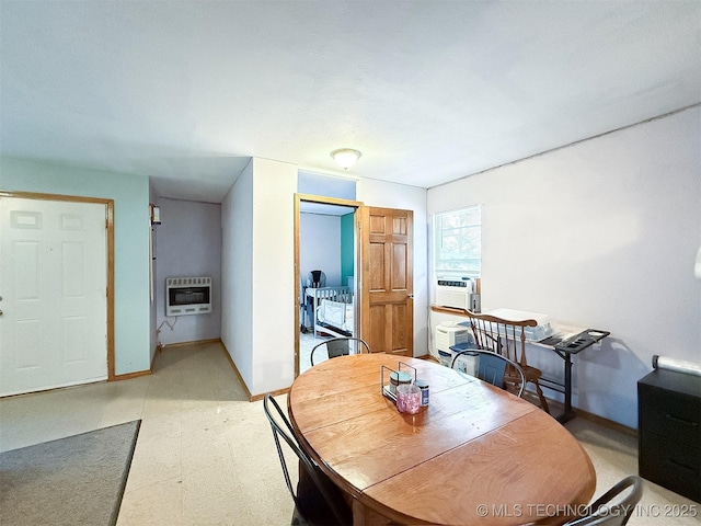 dining area featuring baseboards, heating unit, light floors, and cooling unit