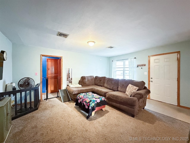 living area with visible vents and carpet