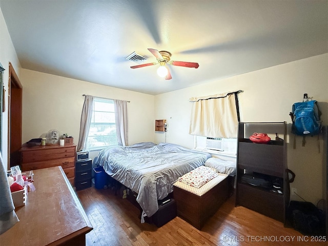 bedroom featuring visible vents, wood-type flooring, and ceiling fan