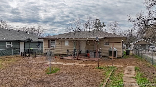 rear view of property featuring a patio area and fence