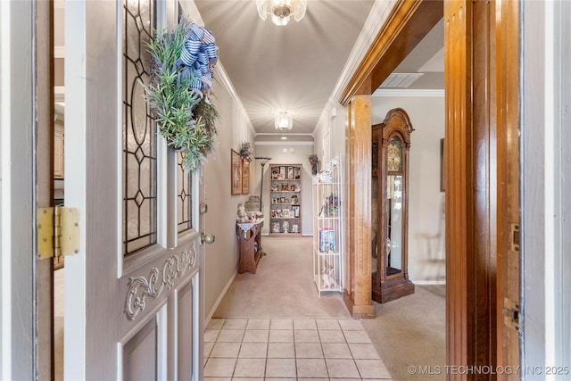 entryway with light carpet, light tile patterned floors, crown molding, and decorative columns