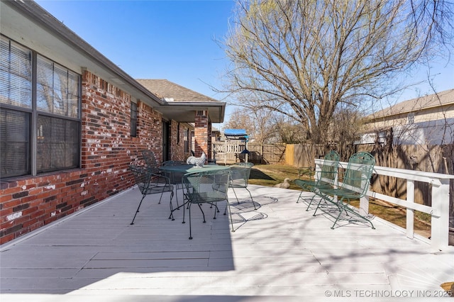 wooden terrace with fence private yard and outdoor dining area