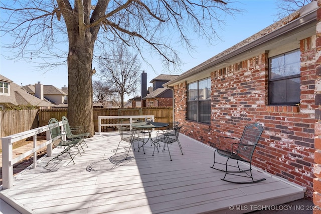 wooden deck featuring outdoor dining area and fence