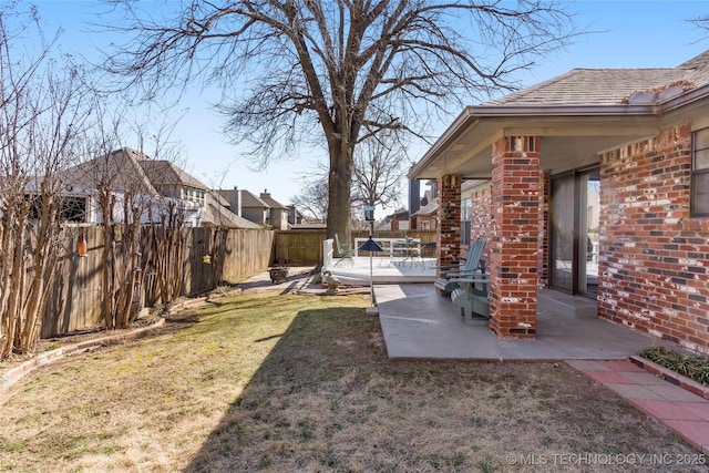 view of yard with a patio area and a fenced backyard