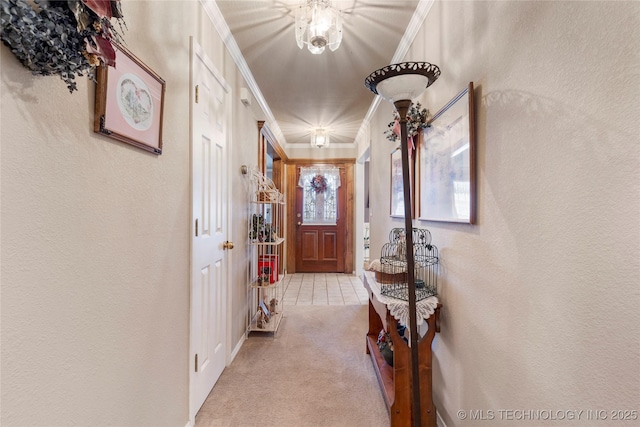 hall with crown molding, a textured wall, and light carpet