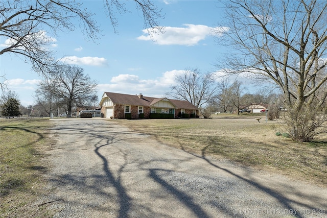 exterior space with driveway, a front lawn, and a garage