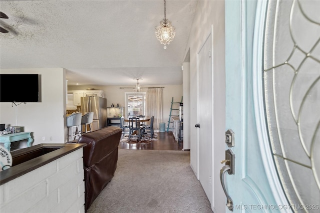 carpeted living room featuring a textured ceiling